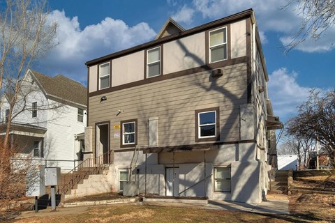 A two-story building with a brown and beige exterior.